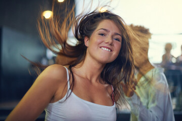 Young woman dancing to the music at a concert. This concert was created for the sole purpose of...