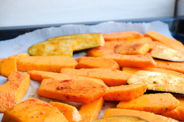 Grilled vegetables baked in the oven. Pieces of pumpkin, eggplant, Aubergine and zucchini on parchment on a baking sheet. Healthy vegan organic meal. Superfood and health care. Immune system support.