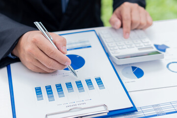 Accountants analyze company performance graphs for profit and growth. Market Research Reports and Revenue Statistics concept of finance and Businessmen discuss charts and graphs showing resolution.