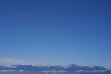 Blue sky and contrails over the mountains of the Southern Alps