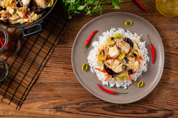 Chinese style cod, served on a plate with white rice.