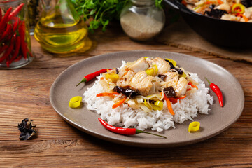Chinese style cod, served on a plate with white rice.