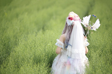 Beautiful young woman with white lolita dress with flowers garden Japanese fashion