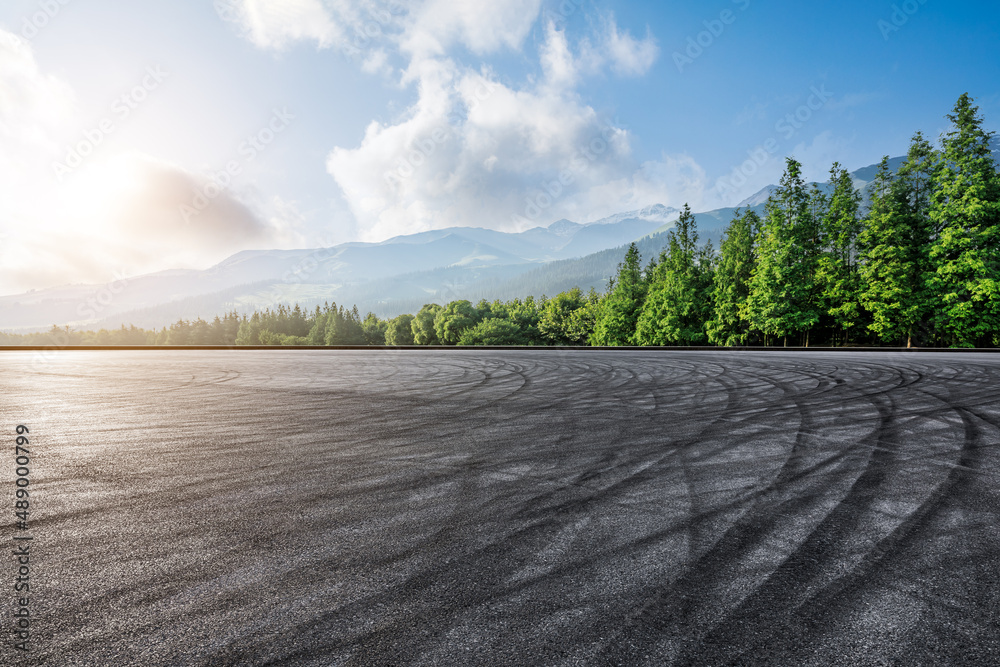 Wall mural Empty asphalt road and green forest with mountain scenery at sunrise