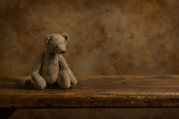 Retro teddy bear on wooden shelf