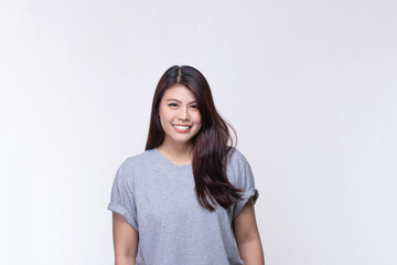 Obraz premium Image of feeling smile and happy. Cheerful young asian woman with brunette long hair in casual shirt smiling with teeth on white. Female face expressions and emotions concept.