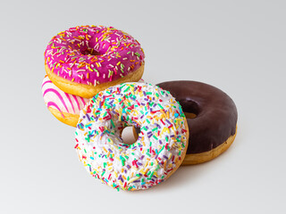 Delicious bright donuts with multicolored glaze, on a light background