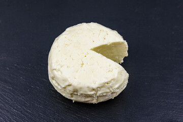 Piece of adyghe cheese on a slate board