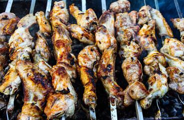 shish kebab of chicken on skewers is fried on coals. It looks appetizing and delicious, and the aroma plays up the appetite