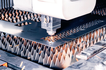 Metal cutting machine. Laser cutting. Sparks from laser cutting. Close-up.