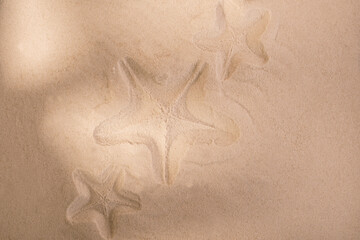 Starfish trace on a sand surface. Summerbackground good for Seasonal Sale or Tour Trip announce.