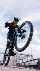 man wearing a helmet jumping in a bike in the street