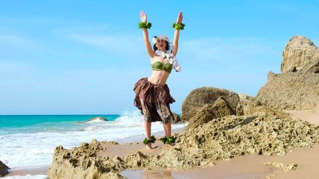 Graceful woman dacing hawaiian dance on the beach. Silhouette with blanks.