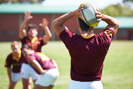 Pass the ball. Rearview shot of a young rugby player taking a lineout.