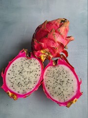 The pitaya or dragon fruit or jelly fruit, white, cut in half, top view. The fruit of Hylocereus undatus .
