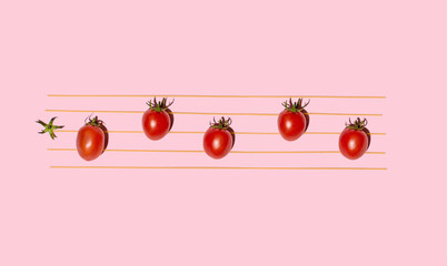Cherry tomatoes and spaghetti, minimal creative arrangement, popular Italian pasta recipe.