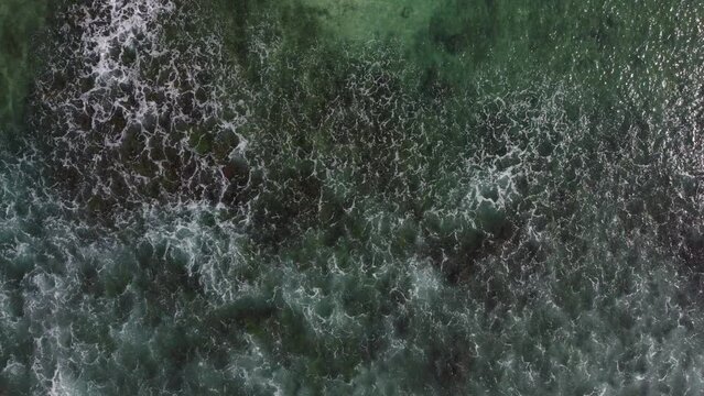 Aerial view of an emerald green sea and big foaming waves. Indian Ocean. Sri Lanka.