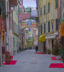 Fototapeta na wymiar colorful narrow street in the town center.Celle Ligure,Liguria,Italy