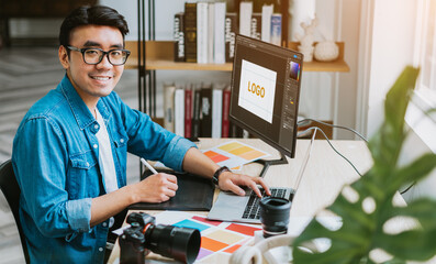 Young Asian designer working at office - obrazy, fototapety, plakaty