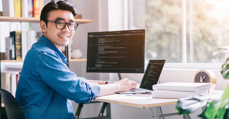 Young Asian programmer working at office