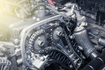 New car timing chain on a diesel old engine in a car workshop. Close up. Blur effect.