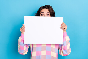 Photo of young lady cover half face paper banner promoter spy watch isolated over blue color...