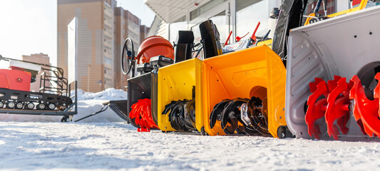 A new petrol snowplow is on sale. Snow removal mechanism. A device for snow removal at home in...