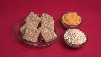 Indian makar sankranti festival food or sweets. Tilgul in a small bowl. Tilgul is made out of sesame seeds, peanuts, and jaggery. Til gud chikki or sesame candy. Copy Space.