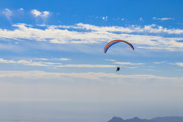 Paragliders flying from a top of Tahtali mountain near Kemer, Antalya Province in Turkey. Concept of active lifestyle and extreme sport adventure