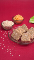 Indian makar sankranti festival food or sweets. Tilgul in a small bowl. Tilgul is made out of sesame seeds, peanuts, and jaggery. Til gud chikki or sesame candy. Copy Space.