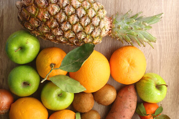 Various healthy fruit and vegetable on wooden background. Top view.
