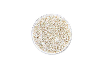White sesame seeds in bowl isolated on white background. Top view. Glass saucer.