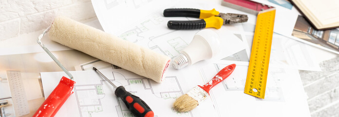 Construction blueprints with tools and tablet, top view