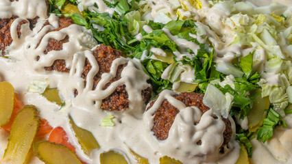 Close-up view of falafel and fresh salad. Vegan tacos. Vegetarian healthy food. Vegetarian falafel with salad on pita.