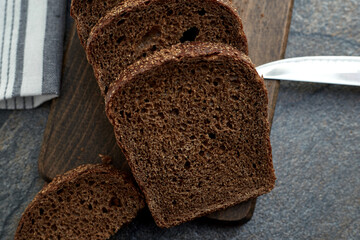 Sliced rye bread on a wooden board