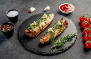 Baked mackerel on a stone background