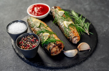 Baked mackerel on a stone background