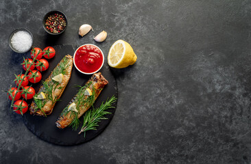 Baked mackerel on a stone background with copy space for your text