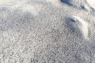 Black soot from the boiler room on white snow. Natural background. Snow mixed with coal soot, poor ecology. Environmental pollution 