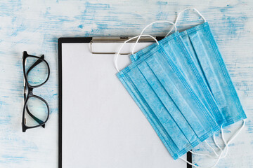 Medical protective masks and glasses on doctor's tablet