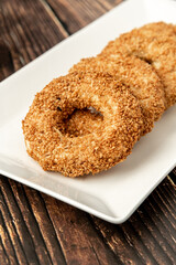 Turkish name Kandil simidi with tea beside it on wooden table. Turkish Bagel with sesame seeds or salty ring cookies.