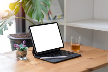 Fototapeta premium Tablet blank screen on desk and workspace background in modern office.