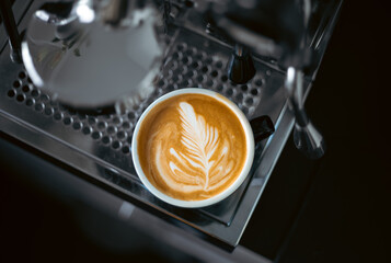 portafilter barista cup of coffee with creamy cappuccino latte art
