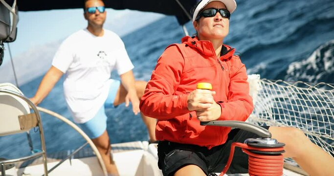 Attractive strong woman sailing with her boat