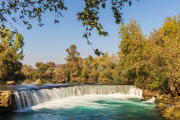 Fototapeta premium Turquoise water of Manavgat River flowing over the Manavgat Waterfall.