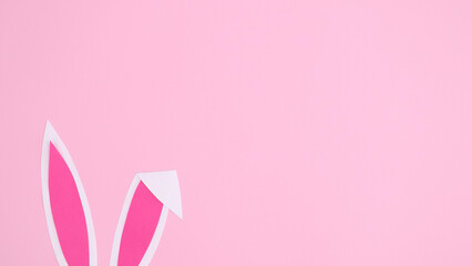 Bunny ears on pastel pink background. Creative copy space theme for Easter holidays. Flat lay concept