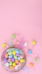 Fototapeta na wymiar Happy Easter creative copy space background with colorful eggs and Easter decorations on pastel pink theme. Flat lay minimal