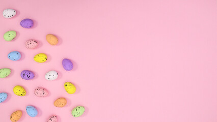 Fototapeta na wymiar Easter copy space background with colorful eggs on pastel pink theme. Flat lay minimal creative layout.