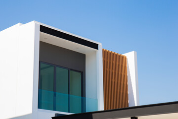 View of a modern style house outside of some buildings.