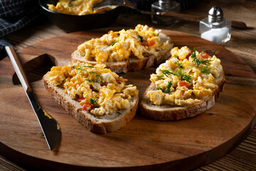 Scrambled eggs on a slice of bread.